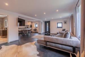 a living room with a couch and a kitchen at Lara Villa in Zepkow
