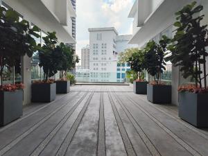 an empty corridor in a building with potted plants at Quill Residence- Minimalist Urban Condo by Azmila in Kuala Lumpur