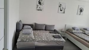 a bedroom with a bed with pillows on it at White Harmony Apartment in Debrecen