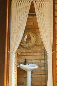 a bathroom with a sink and a mirror at Villa Bali Casas pé na areia in Barra de Ibiraquera +74 photos