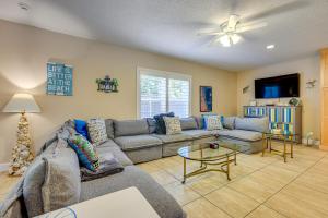 a living room with a couch and a table at St Augustine Island Cottage - Walk to Beach in Saint Augustine