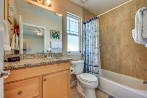 a bathroom with a toilet and a sink and a tub at St Augustine Island Cottage - Walk to Beach in Saint Augustine +27 photos