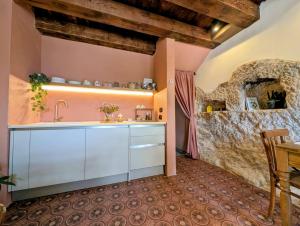a kitchen with a sink and a stone wall at Casa Avella Mountain Retreat in Pennapiedimonte
