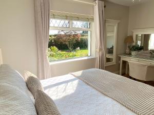 a bedroom with a bed in front of a window at Tranquil Haven Home in Milltown