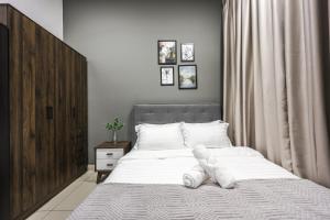 a bedroom with a bed with white towels on it at Trion Kuala Lumpur by Vivid Stay in Kuala Lumpur +53 photos