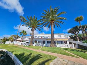 dom z palmami przed nim w obiekcie Madre Tierra Apartment w mieście Puerto de la Madera