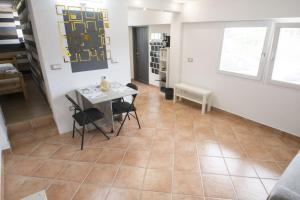 a dining room with a table and chairs on a tile floor at La DaMa in Germignaga +8 photos