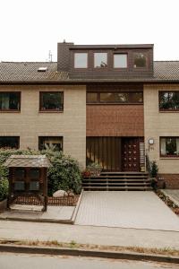 a large brick house with a porch and stairs at HeideHygge 3 in Schneverdingen +31 photos