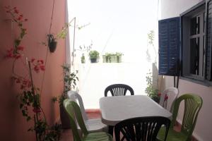 a table and chairs in a room with a window at Dar Ba à 15 min à pied de la mer in Essaouira