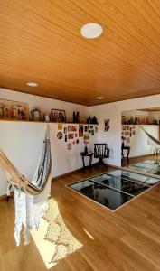 ein Raum mit einem Glastisch und Hängematten darin in der Unterkunft Casas Cor de Rosa in São Martinho das Moitas + 51 Fotos