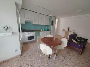 a kitchen and dining room with a table and chairs at Au bord de la plage in Puerto de Sagunto +26 photos
