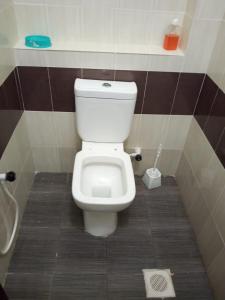 a bathroom with a white toilet in a stall at Mtwapa Homes M Luxury Apartments in Mombasa