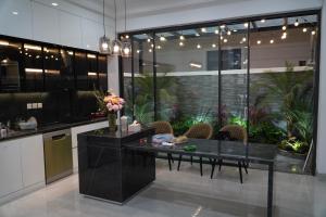 a kitchen with a table and chairs in a room at Vibe Home Vinhomes Ocean Park 2 in Hòa Bình