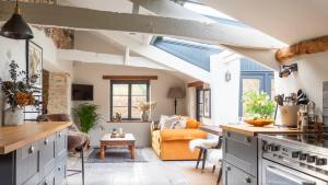 a kitchen and living room with an open ceiling at Riverside Retreat in Totnes