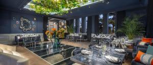 a dining room with tables and chairs and windows at The Komana Binbirdirek in Istanbul