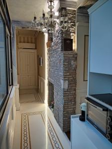 a hallway with a stone wall and a chandelier at Piazza Venezia appartamento con vista in Rome