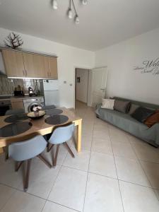 a living room with a table and a couch at Apartment Alexis Stefanos in Himare
