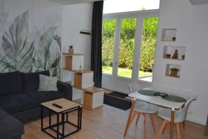 a living room with a couch and a table at Maison 'la grange' in Clion