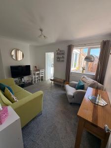 a living room with a couch and a table at Valeries House 4 Bed 2 Bath close to beach in Gorleston-on-Sea