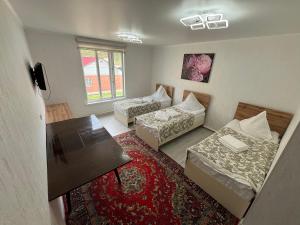 a living room with two couches and a table at Lovable in Naryn