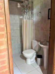 a bathroom with a toilet and a sink at Chale Nha Chica in Alagoa