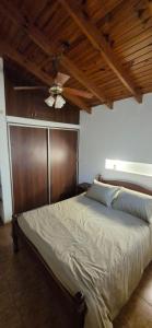 a bedroom with a bed with a ceiling fan at Casa de Campo in San Isidro +9 photos