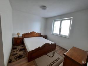a bedroom with a bed and a window at Dabi's apartment in Ferizaj