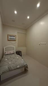a bedroom with a bed and a air conditioner at hajer221 in Al Hofuf