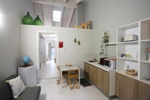 a kitchen with a counter and a table in a room at New Ulivo Apartment 4 in Seriate