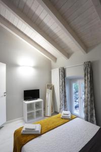 Postel nebo postele na pokoji v ubytování New Ulivo Apartment 4 + 10 fotografií