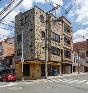 an old stone building on the corner of a street at Parque de Envigado a 350 mts, 2bd, 500mb internet in Envigado