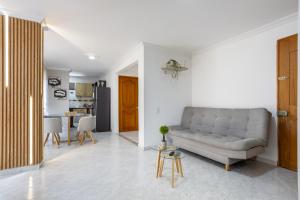 a living room with a couch and a table at Parque de Envigado a 350 mts, 2bd, 500mb internet in Envigado +15 photos
