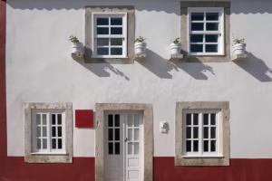two views of a building with two windows and a door at Segredos da Muralha in Óbidos