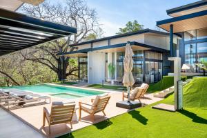 a house with a swimming pool in the yard at Epic Tamarindo Boutique Hotel in Tamarindo