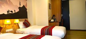 Postel nebo postele na pokoji v ubytování Hotel Sherpani