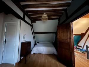 a bedroom with a bed and a wooden floor at Country house - 75 min to Paris in Saint-Maixme-Hauterive