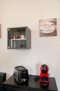 a room with a table with a toaster and a toaster and a blender at lacasadikira in Lucca