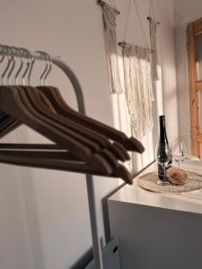 a wine rack with a bottle and a glass on a counter at Ubytování TradiceJinak in Dolní Dunajovice