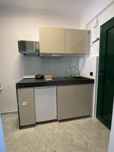 a kitchen with a sink and a counter top at Epic Studios Kallithea in Kallithea Halkidikis