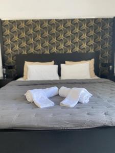 two towels are sitting on top of a bed at Epic Studios Kallithea in Kallithea Halkidikis +18 photos