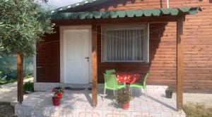 a patio with a table and chairs in front of a house at Villa Ajla in Borsh