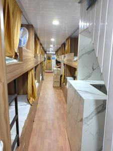 a hallway with marble counter tops and wooden shelves at Sun Shine AC Dormitory in Mumbai +44 photos