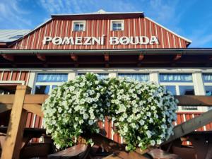 a flower basket on a fence in front of a building at Pomezní bouda in Horní Malá Úpa