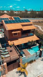 an aerial view of a house with solar panels on its roof at POUSADA ONDA CARIOCA in Cabo Frio +64 photos