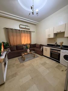 a living room with a couch and a table in it at Modern studio near the center in Marrakech