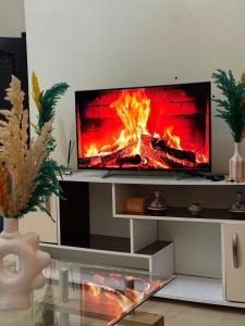 a tv sitting on a table with a fire on it at Modern studio near the center in Marrakech