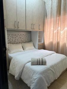 a bedroom with a white bed with a towel on it at Modern studio near the center in Marrakech