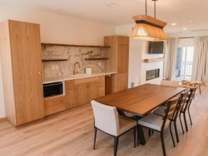a kitchen with a wooden table and chairs at The Shoreline Hotel in Spring Park