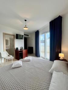 una camera da letto con un grande letto con tende blu di Rooms del Moro a Patù