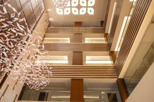 a spiral staircase in a building with a chandelier at Kertel Suites Kinshasa in Kinshasa